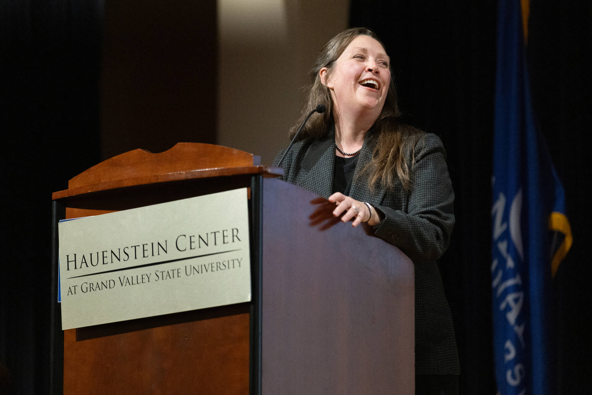Molly Beer speaks from the lecturn